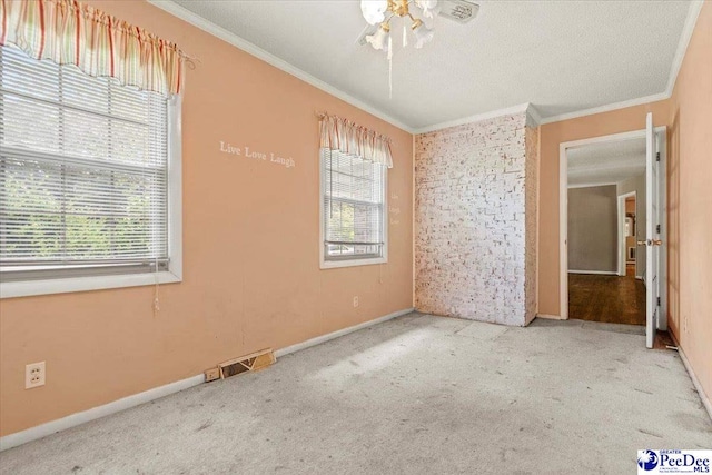 unfurnished bedroom featuring ornamental molding, carpet flooring, and a textured ceiling