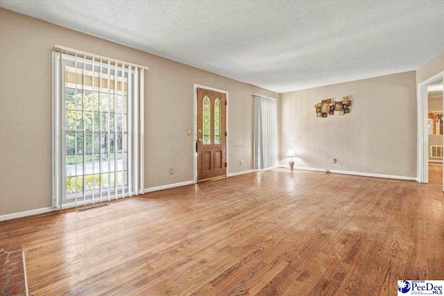 interior space with hardwood / wood-style floors and a textured ceiling