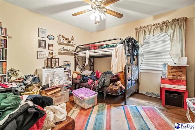 bedroom with wood-type flooring and ceiling fan