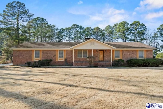 ranch-style home with a porch and a front yard