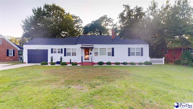 ranch-style home with a garage and a front yard