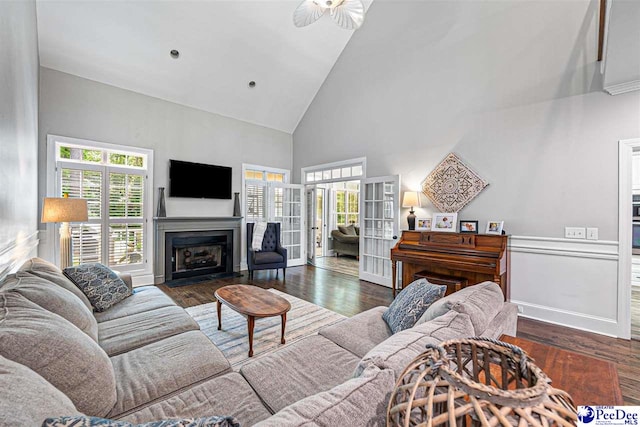 2409 Sarazen Ct, Florence, SC 29506 - living area featuring high vaulted ceiling, plenty of natural light, wood finished floors, ceiling fan, and a fireplace with flush hearth
