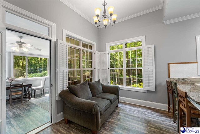 2409 Sarazen Ct, Florence, SC 29506 - sitting room featuring a chandelier, dark wood finished floors, plenty of natural light, baseboards, and crown molding