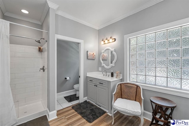 2409 Sarazen Ct, Florence, SC 29506 - bathroom with plenty of natural light, toilet, wood finished floors, a shower stall, and crown molding