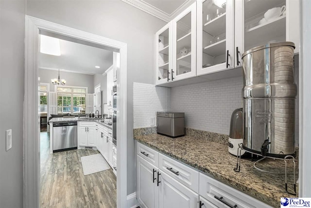 2409 Sarazen Ct, Florence, SC 29506 - kitchen featuring dishwasher, ornamental molding, light wood-style flooring, tasteful backsplash, and white cabinets