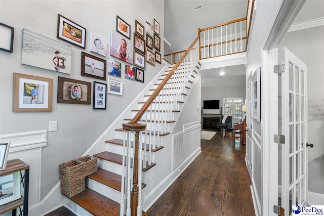 2409 Sarazen Ct, Florence, SC 29506 - stairs featuring wood finished floors and crown molding