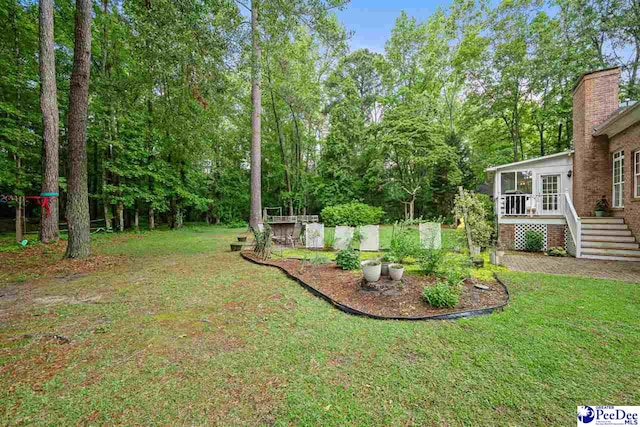 2409 Sarazen Ct, Florence, SC 29506 - view of green lawn with stairway and a deck