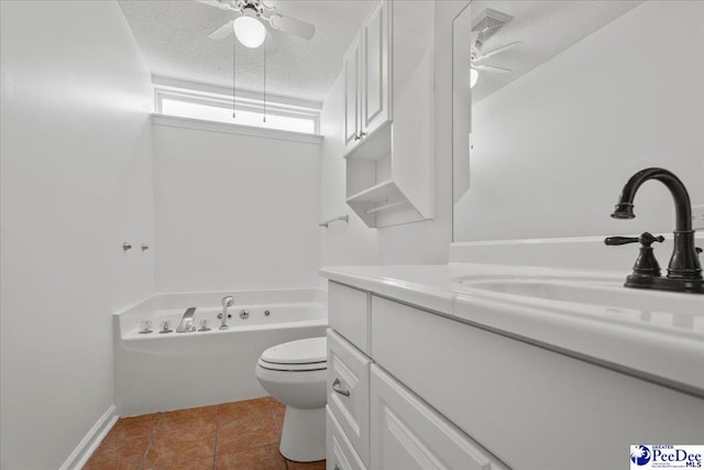 bathroom featuring toilet, vanity, a textured ceiling, tile patterned flooring, and a bath