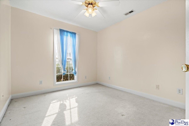 unfurnished room featuring light colored carpet, ceiling fan, visible vents, and baseboards