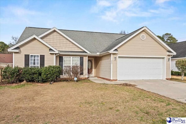 view of front of home with a garage, a front yard, and driveway