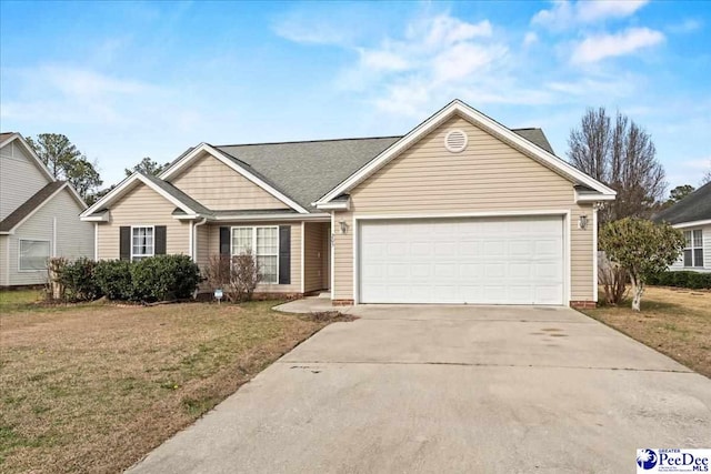 view of front facade featuring a front yard, concrete driveway, and an attached garage