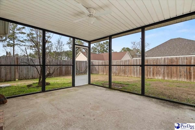 unfurnished sunroom with ceiling fan