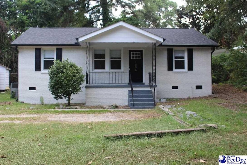 1005 Sunnyside Dr, Cayce, SC 29033 - view of front facade featuring crawl space, brick siding, a porch, and a front lawn
