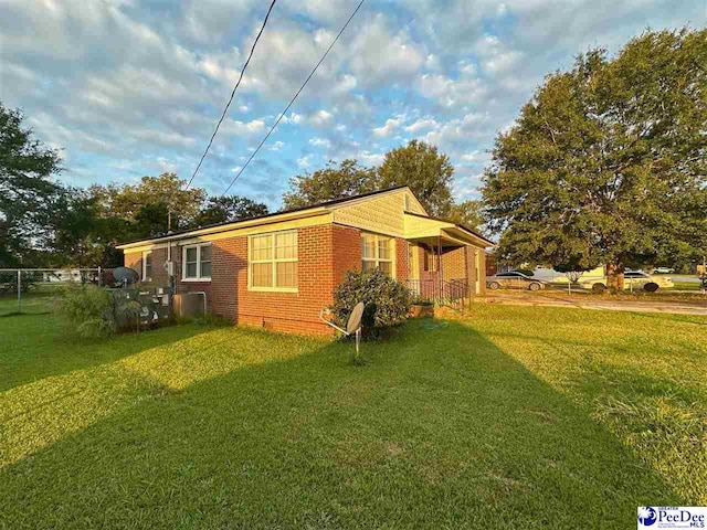 view of property exterior featuring a lawn