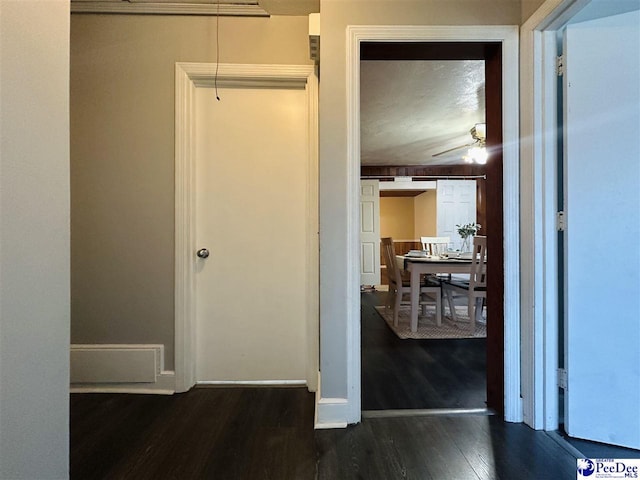 hallway with dark hardwood / wood-style flooring