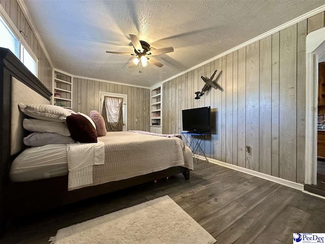 bedroom featuring crown molding, dark hardwood / wood-style floors, a textured ceiling, and wood walls