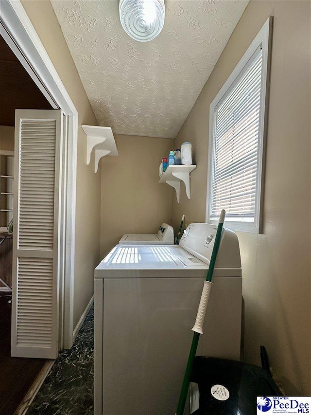 laundry area featuring independent washer and dryer and a textured ceiling