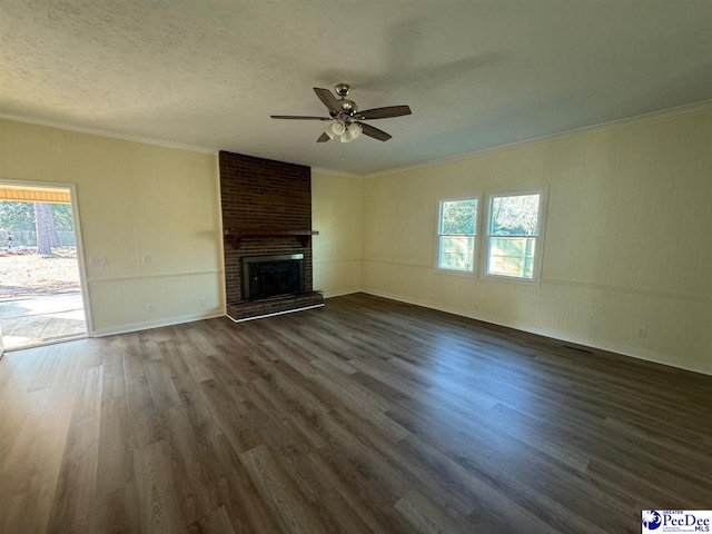 unfurnished living room featuring a brick fireplace, a wealth of natural light, and dark hardwood / wood-style floors