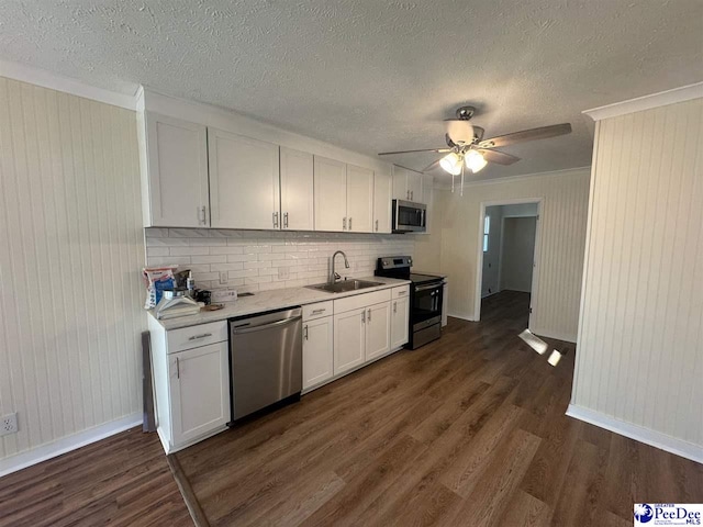 kitchen featuring white cabinetry, appliances with stainless steel finishes, dark hardwood / wood-style flooring, and sink