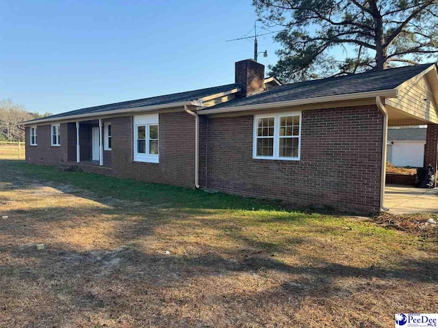 back of property featuring a lawn