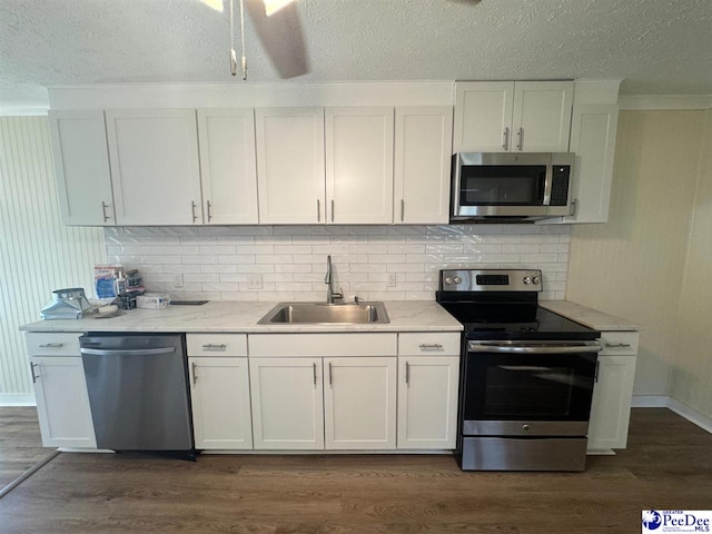 kitchen featuring sink, dark wood-type flooring, stainless steel appliances, and white cabinets