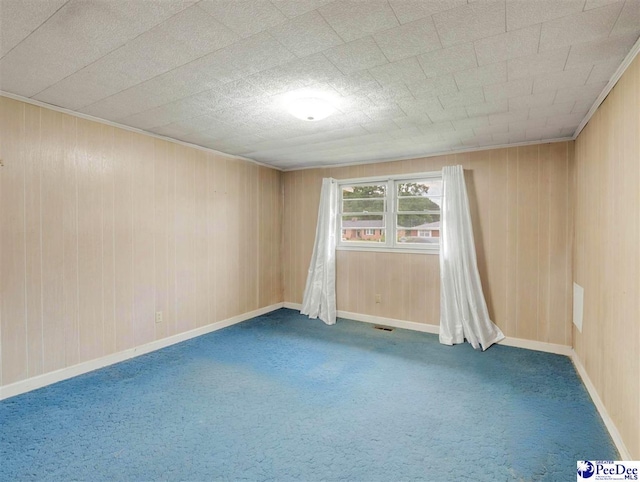 1709 N Irby St, Florence, SC 29501 - empty room featuring carpet, wood walls, and baseboards