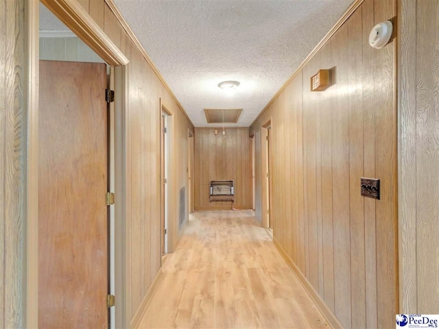 1709 N Irby St, Florence, SC 29501 - corridor featuring a textured ceiling, attic access, light wood finished floors, heating unit, and wood walls