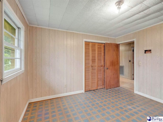 1709 N Irby St, Florence, SC 29501 - spare room featuring baseboards, wooden walls, crown molding, and tile patterned floors
