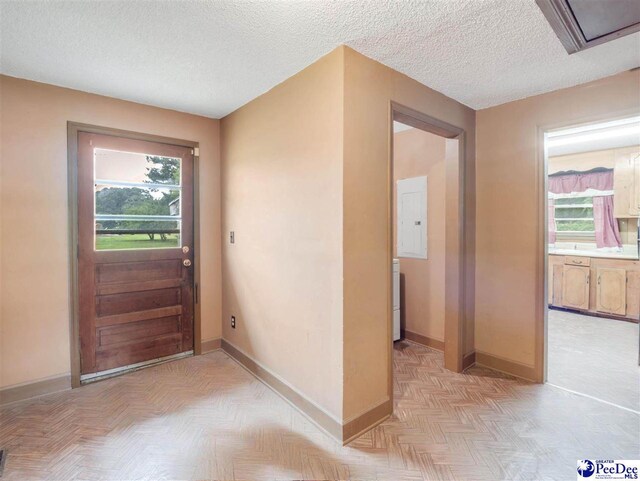 1709 N Irby St, Florence, SC 29501 - foyer featuring baseboards, healthy amount of natural light, electric panel, and a textured ceiling