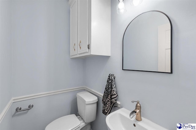 bathroom featuring toilet and a sink