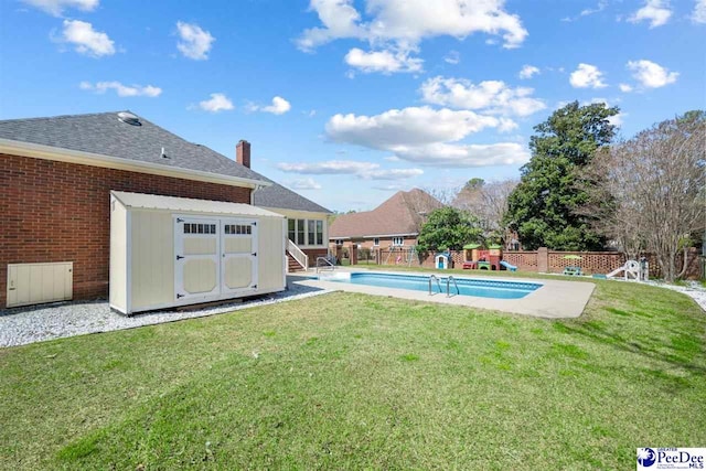 view of pool with a fenced in pool, an outdoor structure, a fenced backyard, a storage unit, and a yard