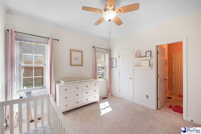 unfurnished bedroom featuring a textured ceiling, visible vents, crown molding, and light colored carpet