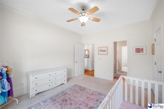bedroom featuring light colored carpet, ceiling fan, baseboards, and ornamental molding
