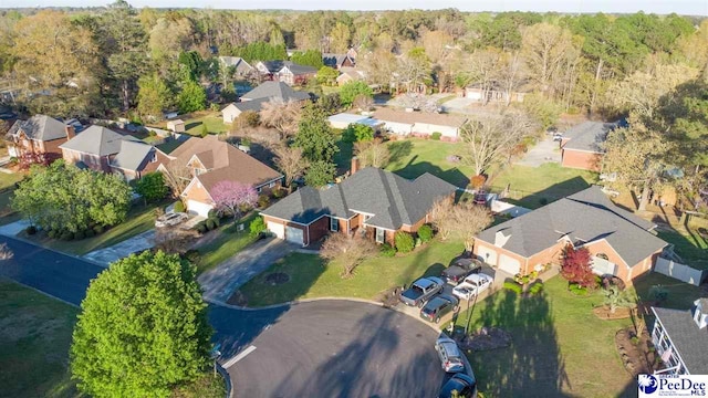 drone / aerial view with a forest view and a residential view