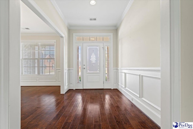 entrance foyer featuring crown molding and dark hardwood / wood-style flooring