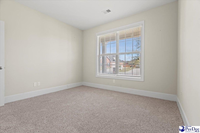 unfurnished room featuring carpet