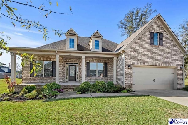 view of front of house featuring a garage, a porch, and a front yard