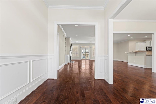 corridor featuring dark hardwood / wood-style flooring and crown molding