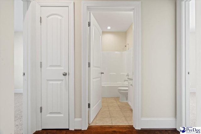 corridor with light tile patterned floors