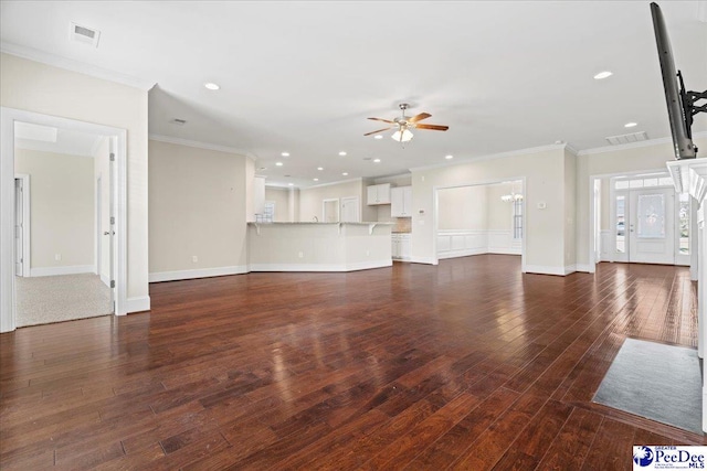 unfurnished living room featuring dark hardwood / wood-style flooring, ceiling fan with notable chandelier, and crown molding