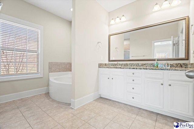 bathroom featuring vanity, tile patterned flooring, and a tub