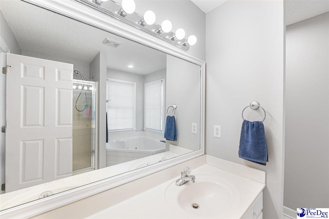 full bathroom with a shower stall, vanity, visible vents, and a bath