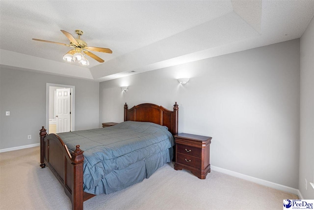 bedroom featuring light carpet, baseboards, a ceiling fan, and connected bathroom