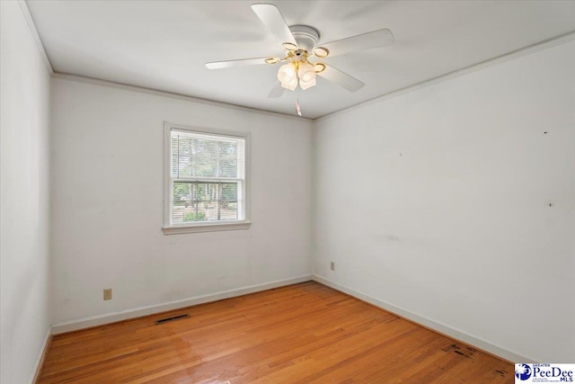 empty room featuring a ceiling fan, baseboards, visible vents, and light wood-type flooring