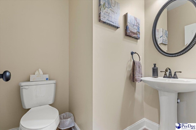 bathroom featuring sink and toilet