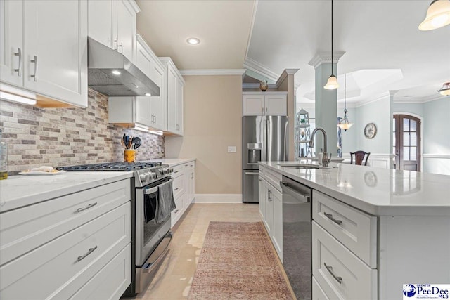 kitchen featuring hanging light fixtures, appliances with stainless steel finishes, a kitchen island with sink, and white cabinets