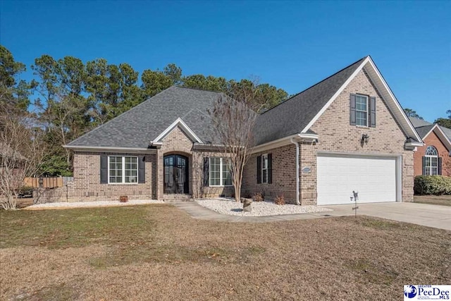 front facade featuring a garage and a front yard