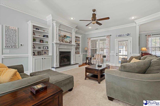 living room with crown molding and ceiling fan