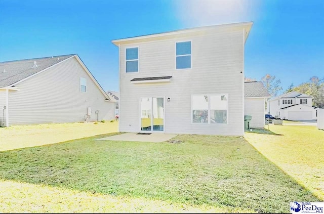 rear view of property with a lawn and a patio