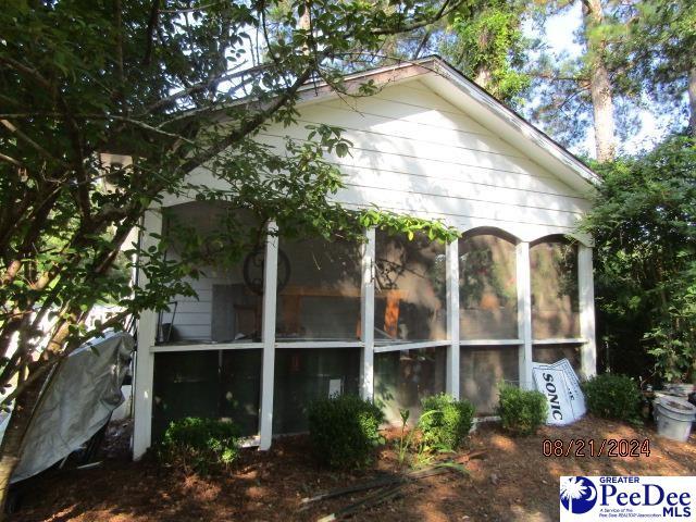 view of home's exterior with a sunroom